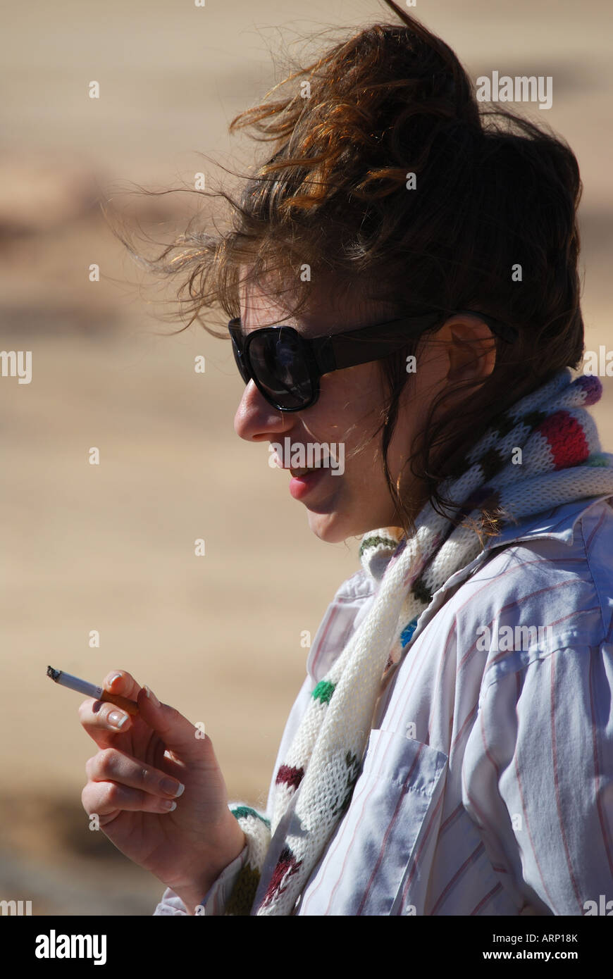 Portrait of young woman smoking cigarette, Sinai Peninsula, Republic of Egypt Stock Photo