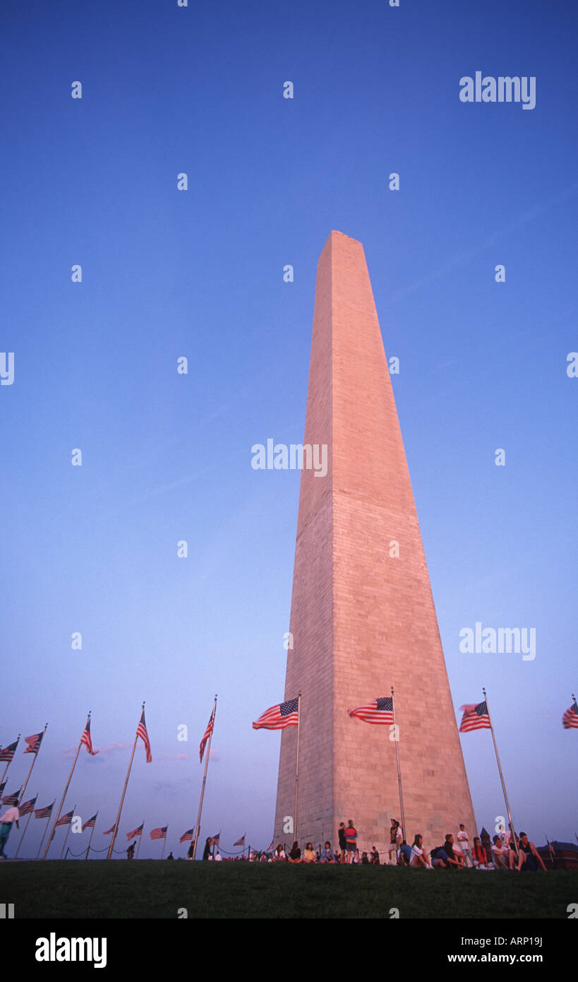 USA, Washington, DC - Washington Monument with visitors under US Flags Stock Photo