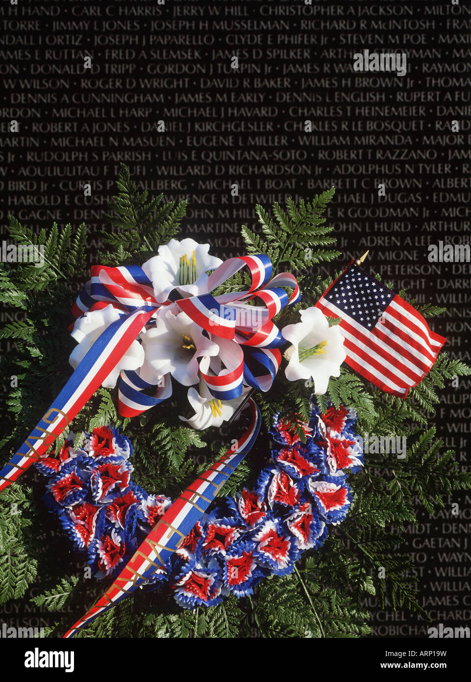 USA, Washington, DC, Vietnam Monument with floral wreath and flag Stock Photo
