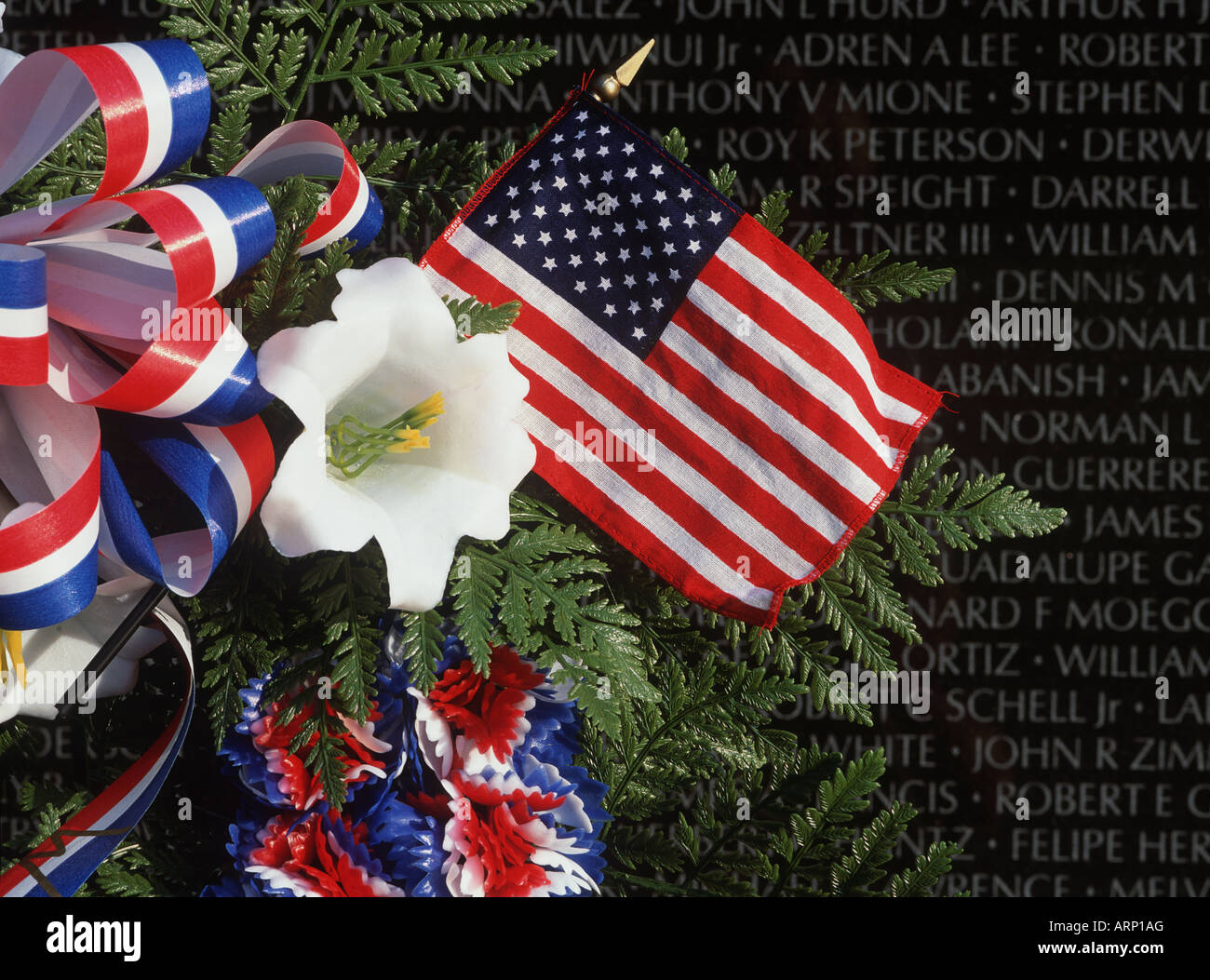 USA, Washington, DC, Vietnam Monument with floral wreath and flag Stock Photo