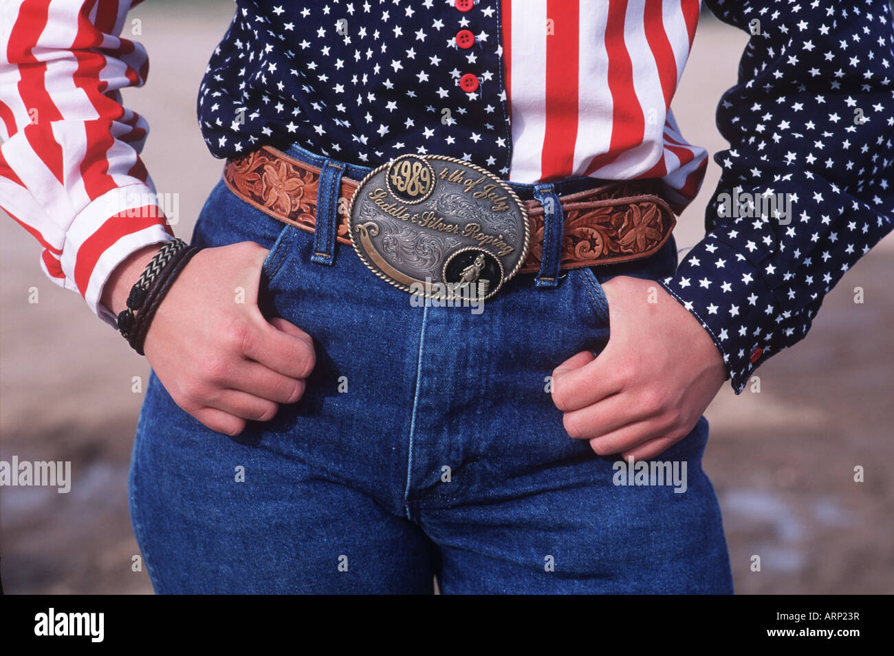 USA, cowgirl with USA shirt and champion belt buckle Stock Photo