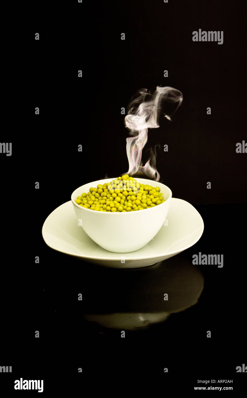 Bowl of hot steaming peas Stock Photo