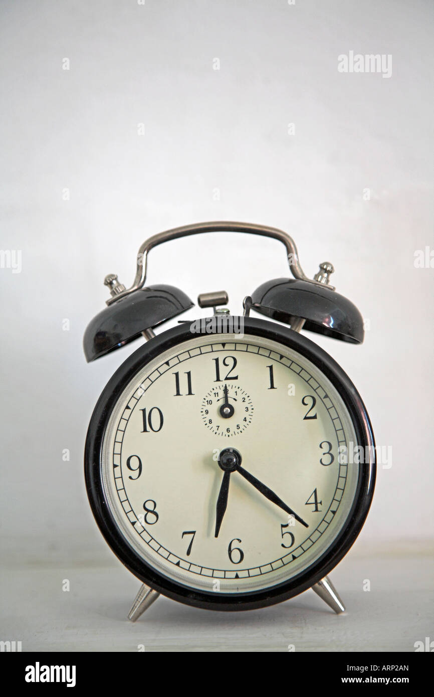 Old fashioned alarm clock white background Stock Photo - Alamy