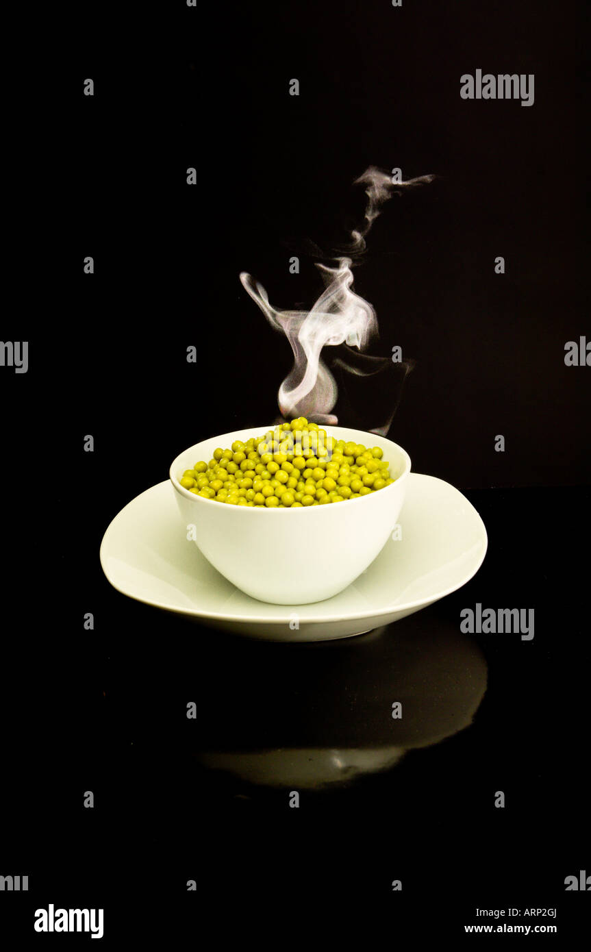 Bowl of hot steaming peas Stock Photo