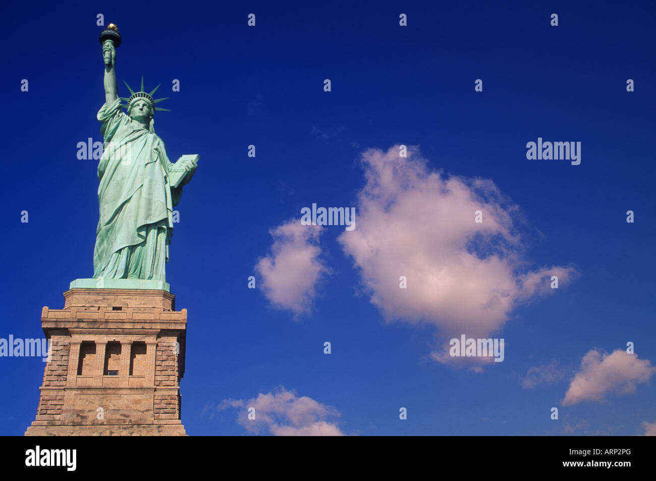 USA, New York City - Statue of Liberty - with cumulus clouds Stock Photo