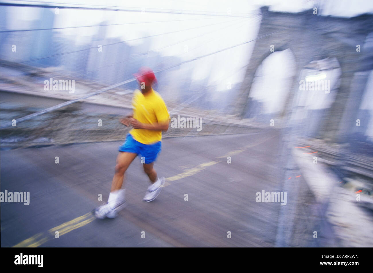 USA, New York City, Single man jogging over the Brooklyn Bridge. Stock Photo