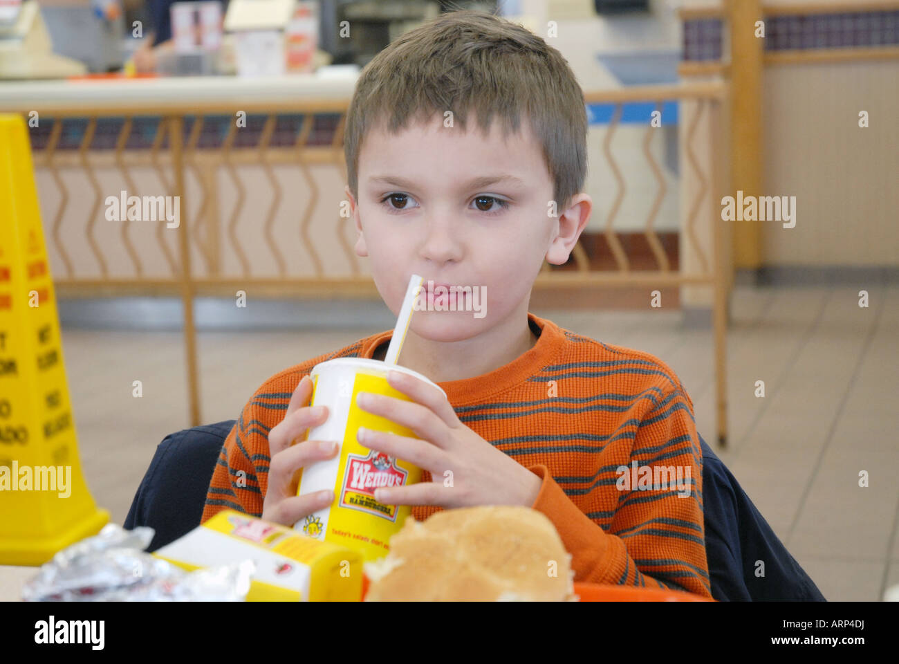 seven-7-year-old-boy-eats-a-fast-food-lunch-at-wendy-s-with-his-family-massachusetts-ma