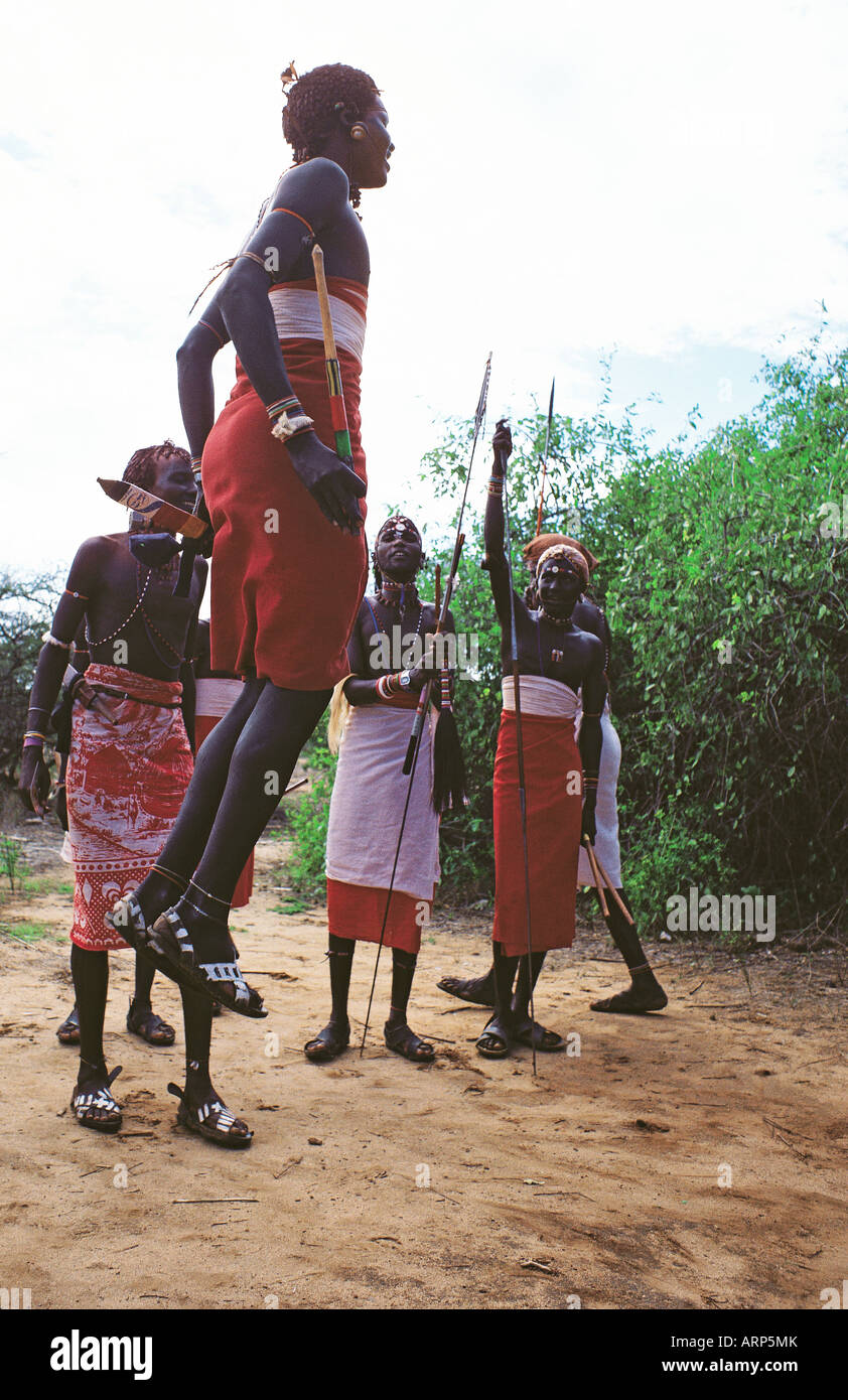 Samburu moran or warriors dancing and leaping jumping in traditional dress Samburu National Reserve Kenya East Africa Stock Photo
