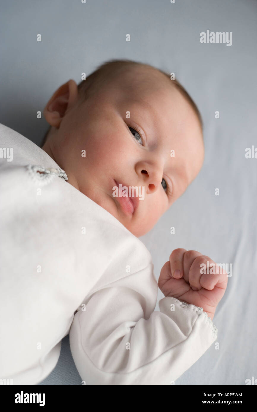 newborn infant boy looking at camera with clenched fist Stock Photo Alamy