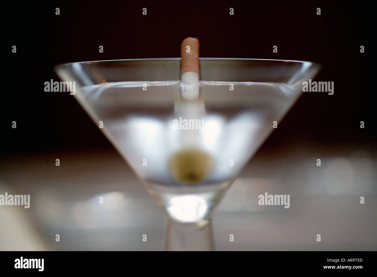 Martini with a cigarette as a toothpick to hold the garnish Stock Photo
