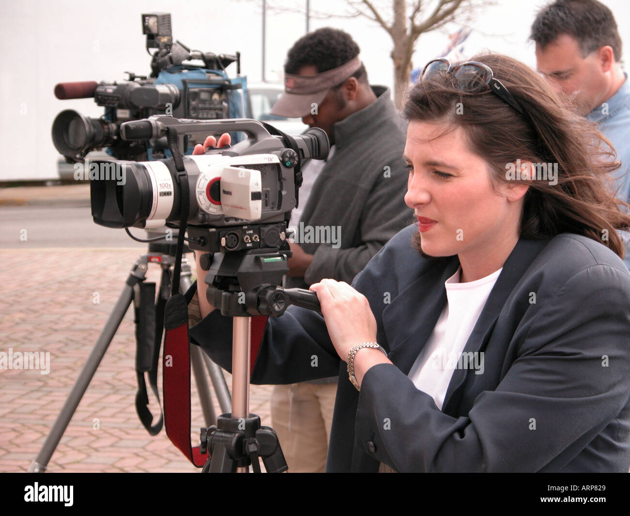 setup and press coverage of failed PRO and Anti war demonstration in Georgia with female woman reporter from TV alone with all men Stock Photo
