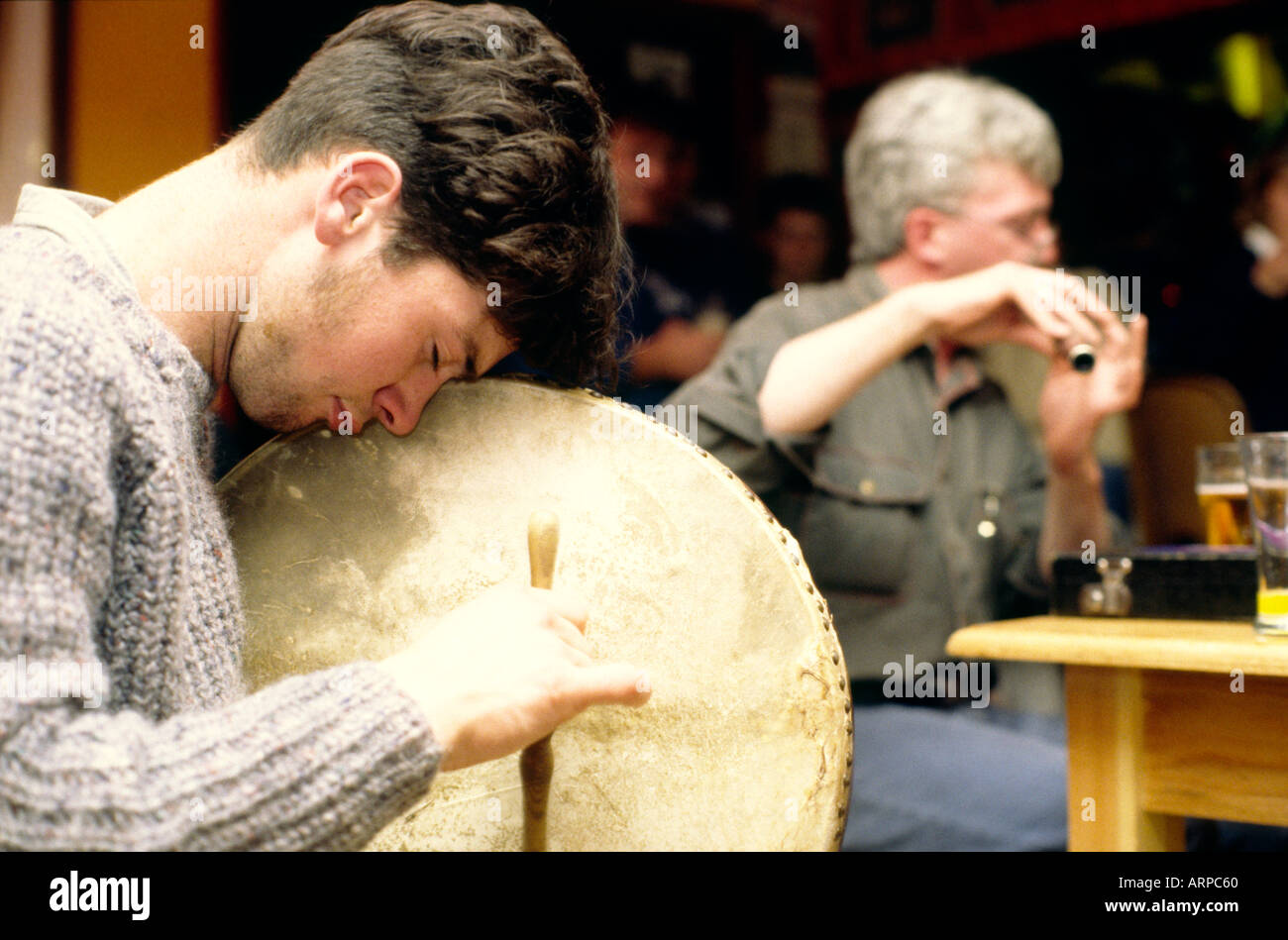 Traditional Irish pub musicians playing bodhran and flute music in a bar in the town of Bantry, County Cork, south west Ireland. Stock Photo