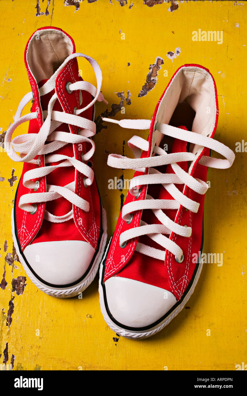 Red tennis shoes on yellow boards Stock Photo