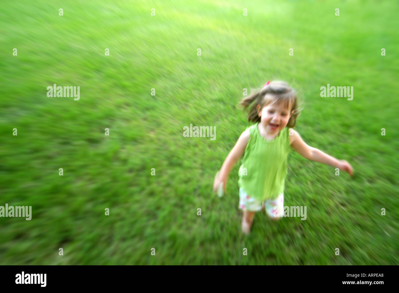 Little Girl Running in Grass Stock Photo Alamy