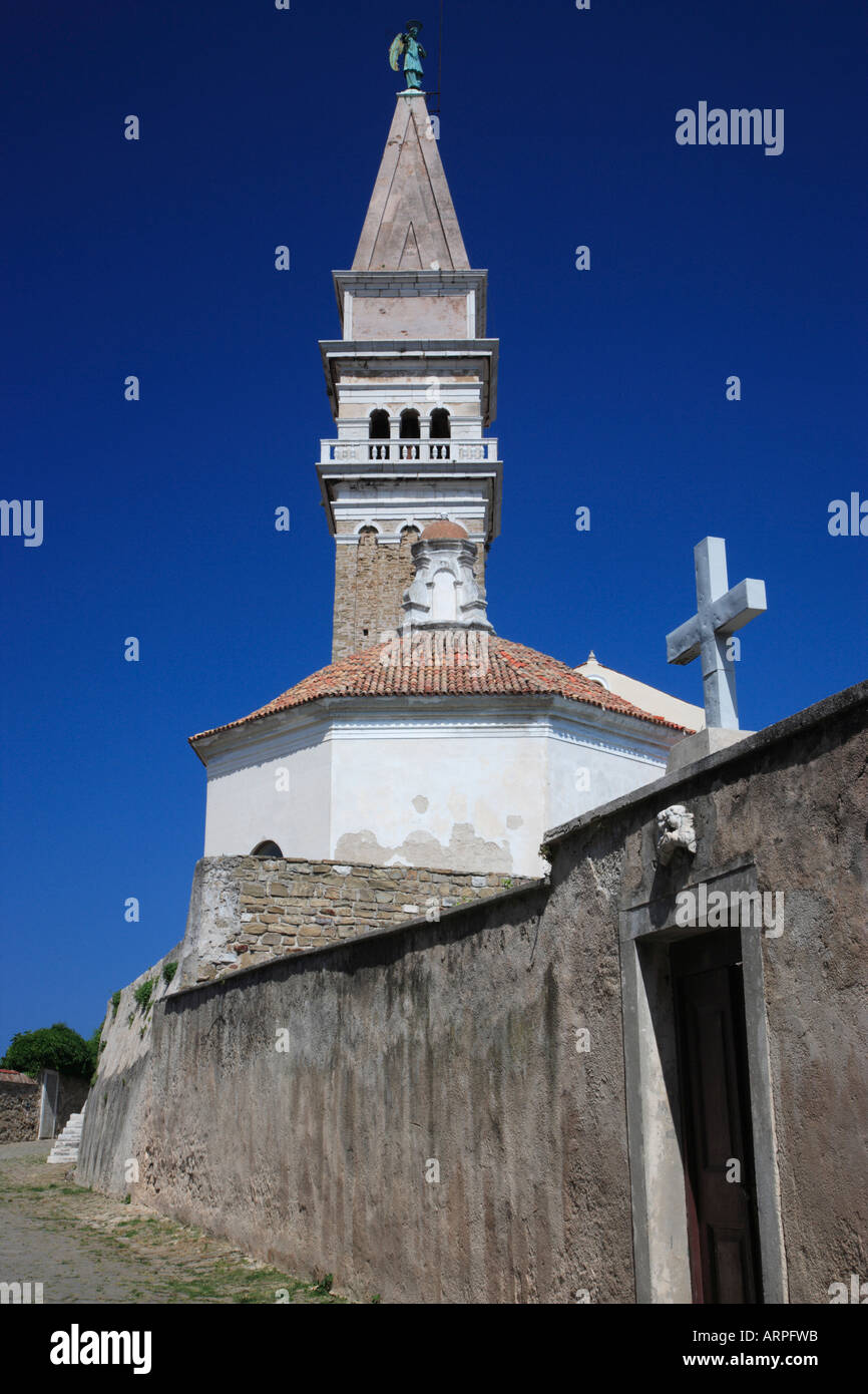 Slovenia Piran The Exterior of Saint George Cathedral Bell Tower and Cemetery Entrance Stock Photo