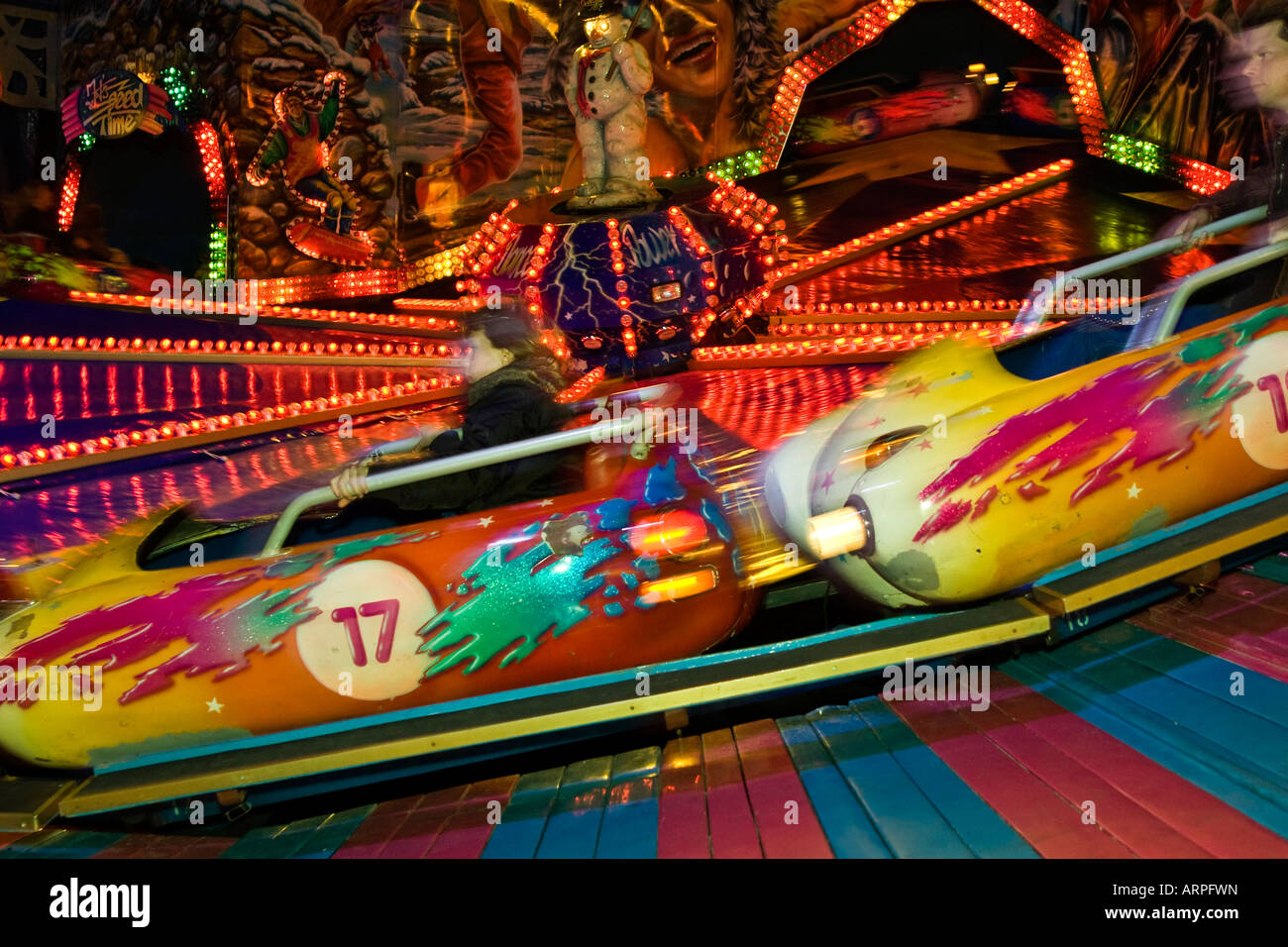 Adults at an amusement park ride Stock Photo - Alamy