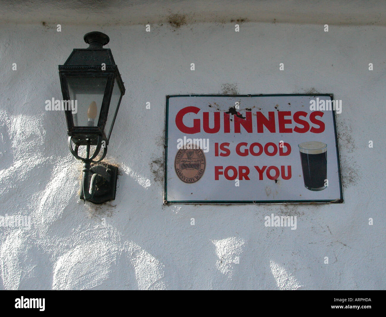 An old Guinness is good for you sign on the wall of a pub in Ireland Stock Photo