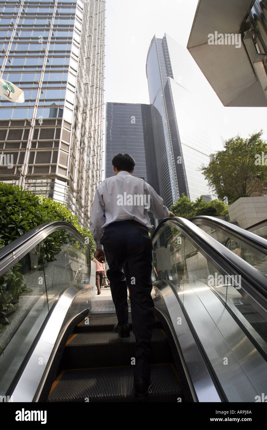 Hong Kong businessman on escalator Stock Photo