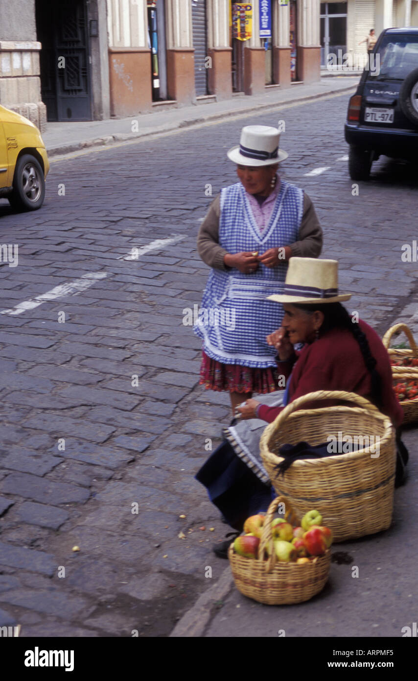 Street scene with two women selling fruit and chuckling in the town of Cuenca in Ecuador Stock Photo