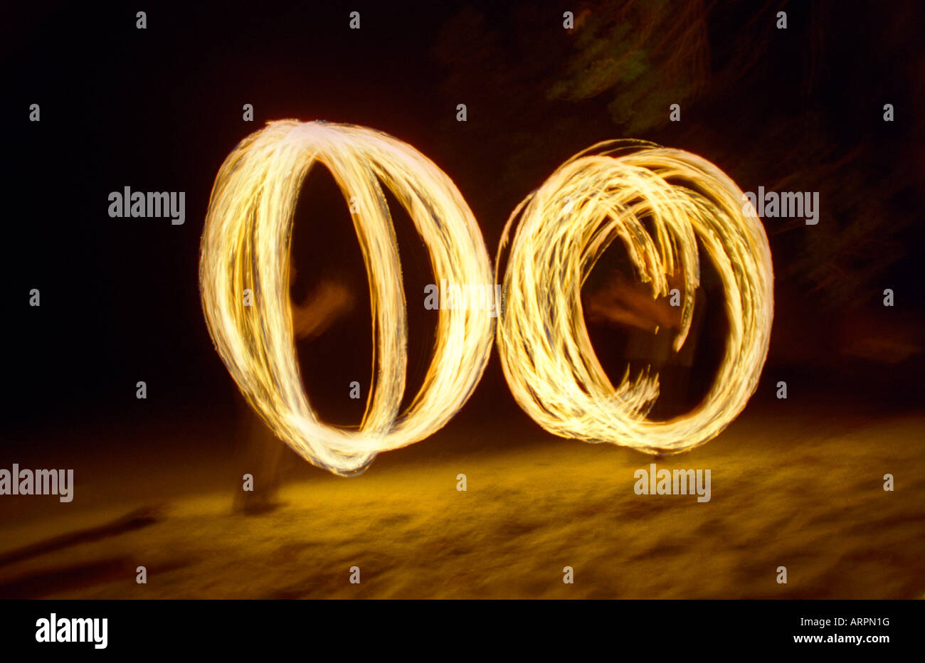 Two men swinging fire chains on Pulau Weh beach Sumatra Stock Photo - Alamy