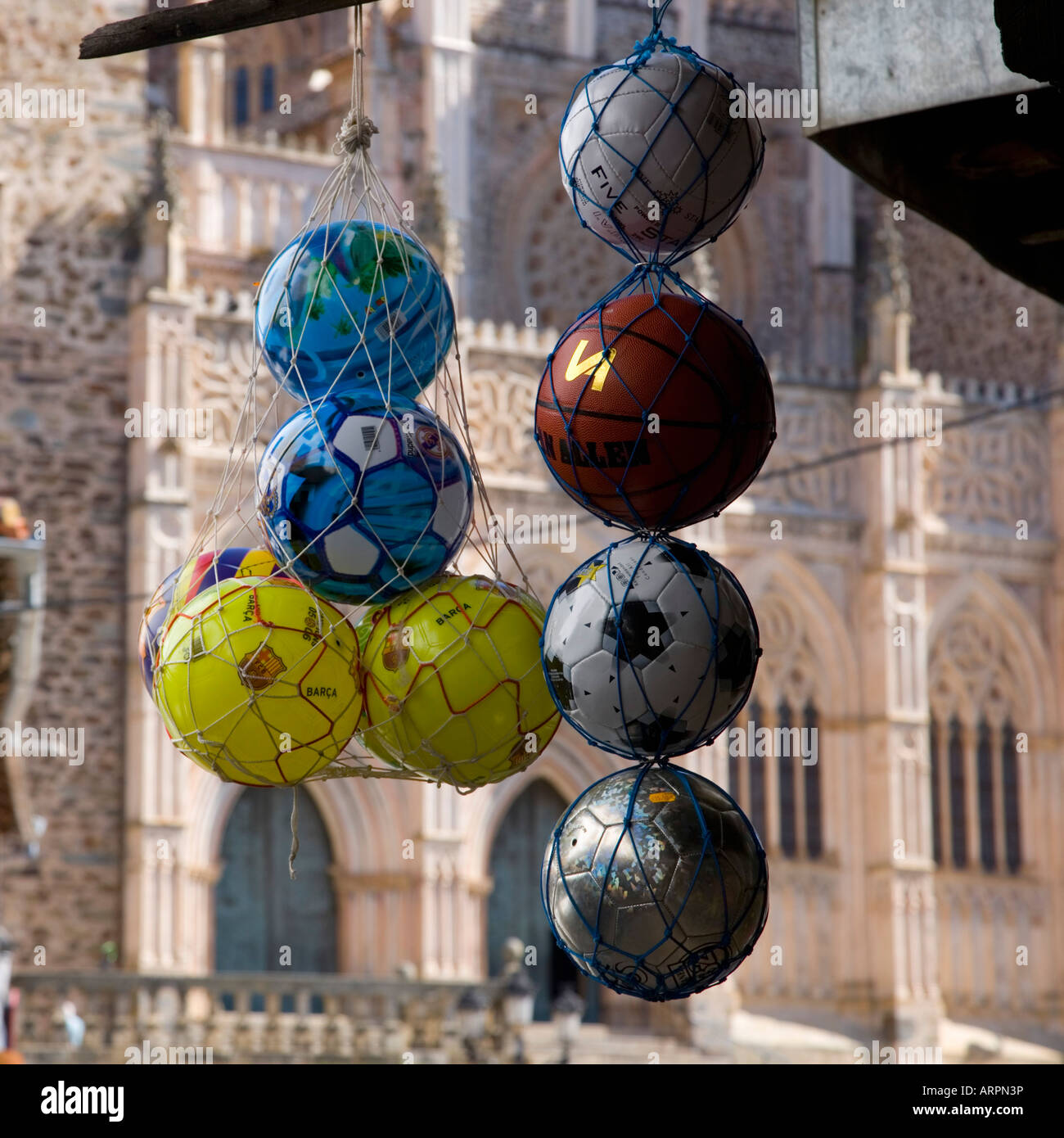 Guadalupe, Extremadura, Spain. Plastic balls for sale outside the Real Monasterio de Santa María de Guadalupe. Stock Photo
