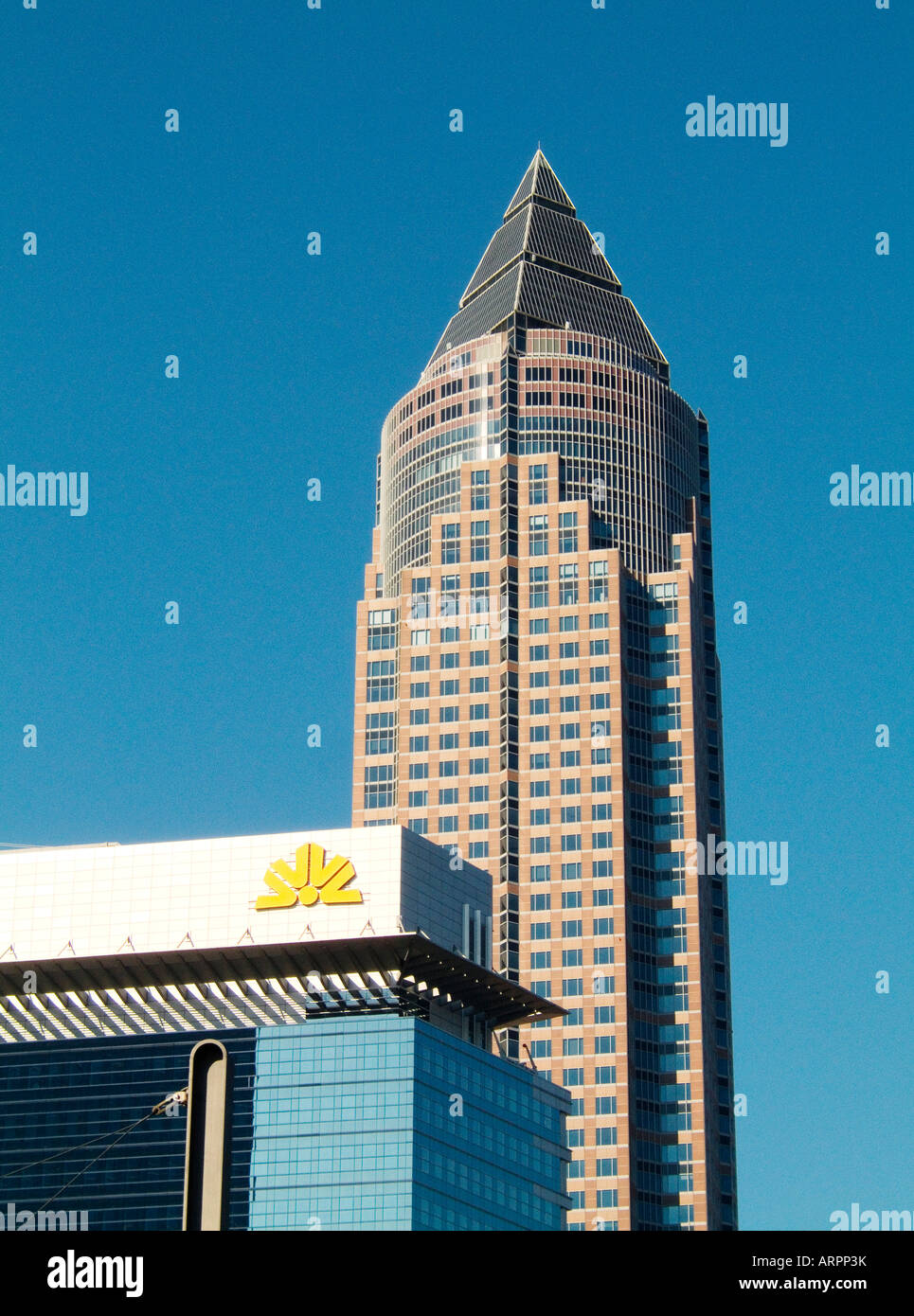The MesseTurm or Trade Fair Tower seen behind the Commerzbank in the Messegelande complex in central area of Frankfurt, Germany Stock Photo