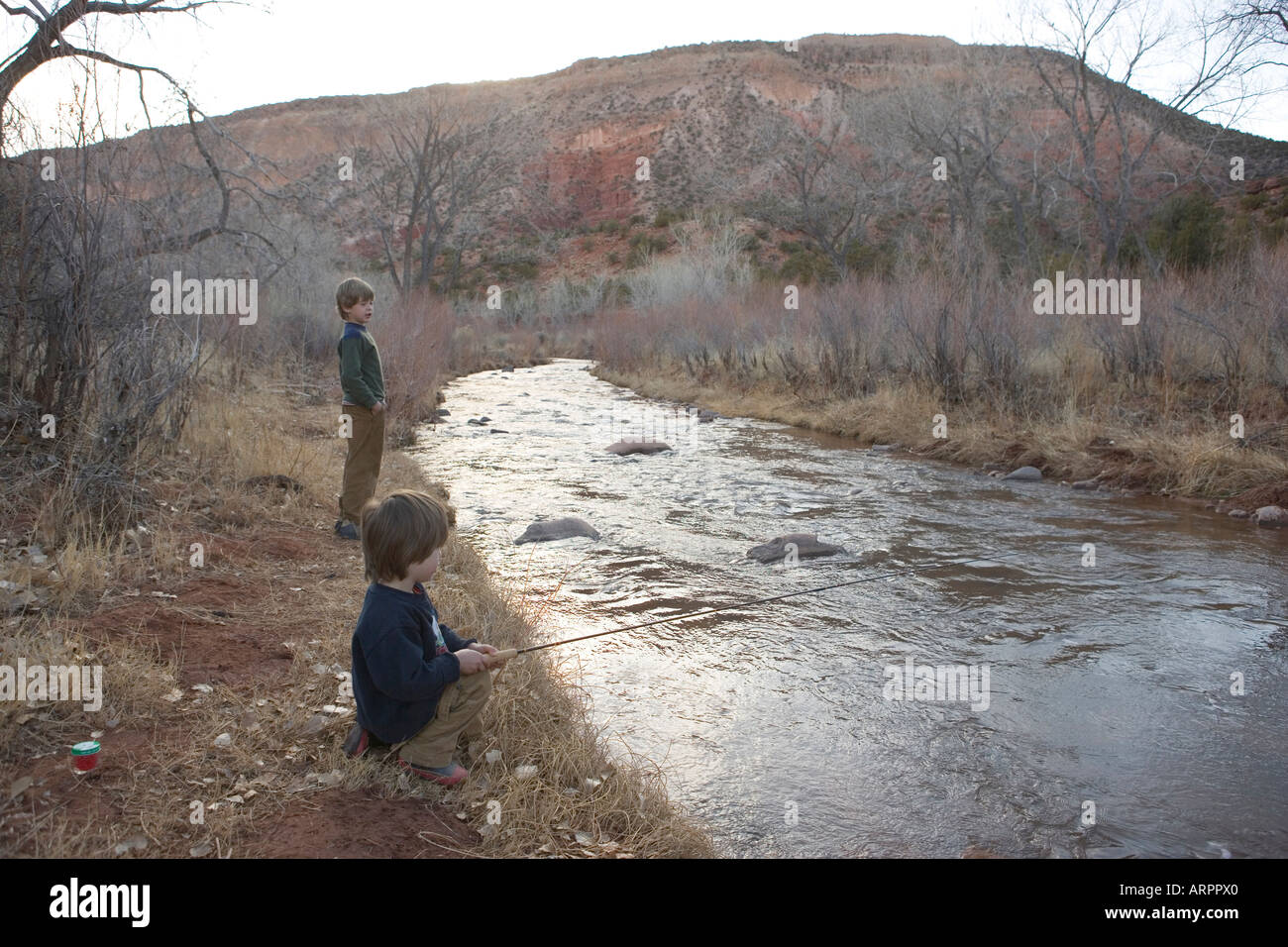 Two boys fishing in river hi-res stock photography and images - Alamy