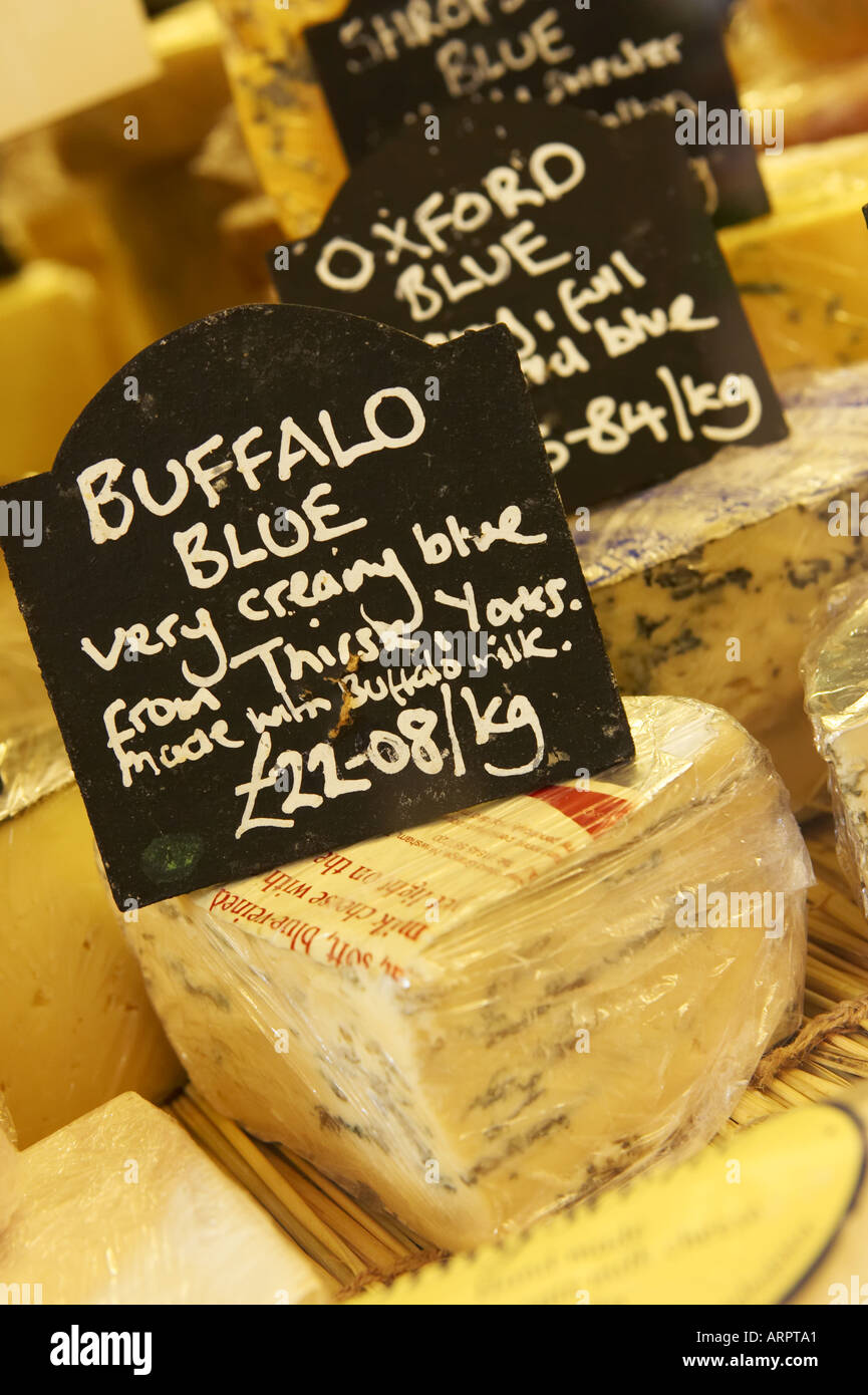 Specialist cheeses in shop window Stock Photo