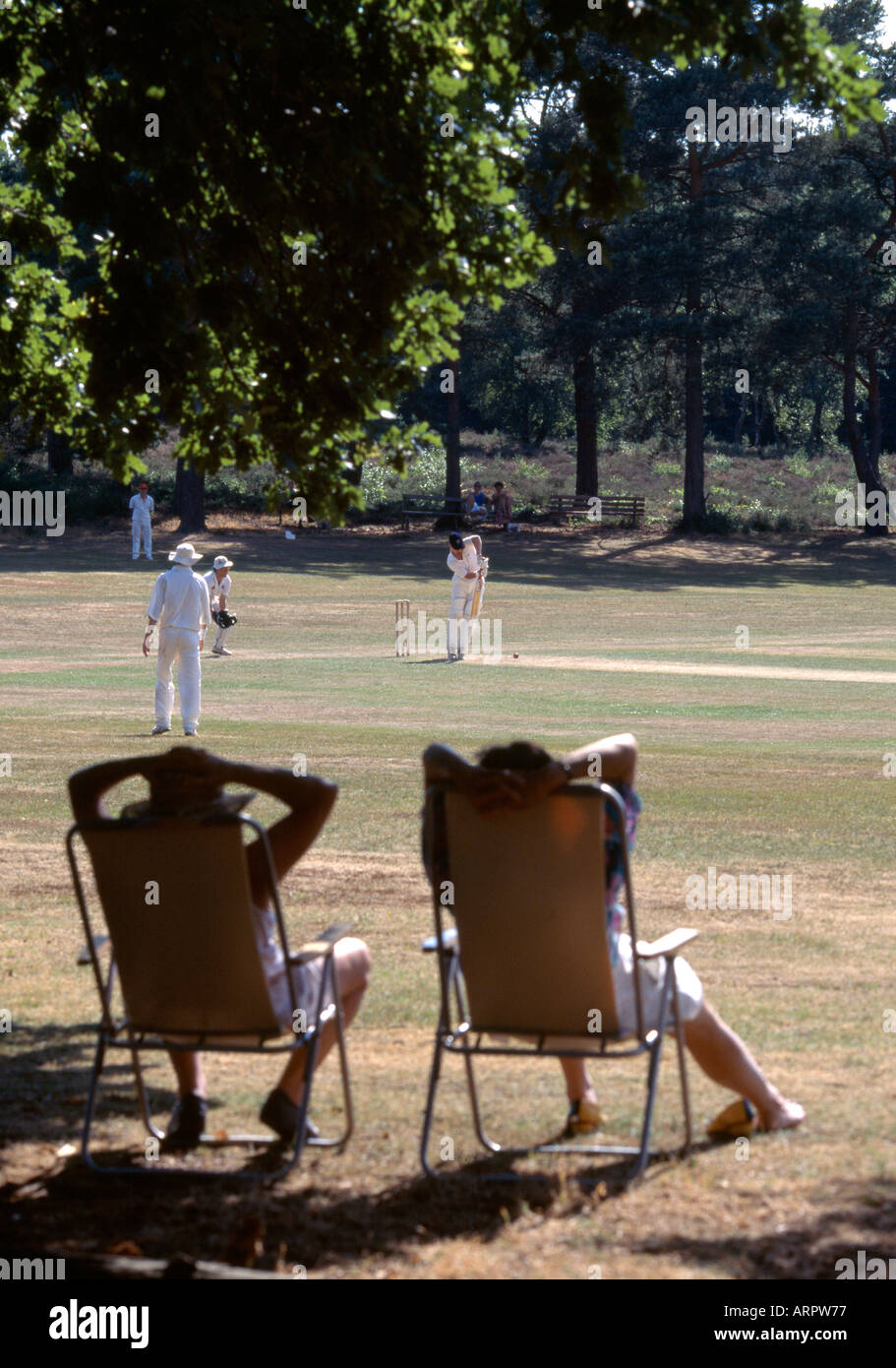 watching village cricket match at Blackheath Guildford Surrey Stock Photo
