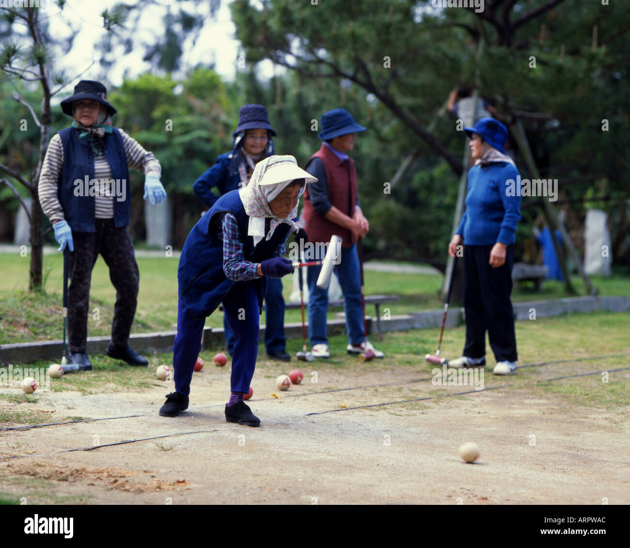 Elderly Okinawan woman plays gateball a Japanese version of croquet