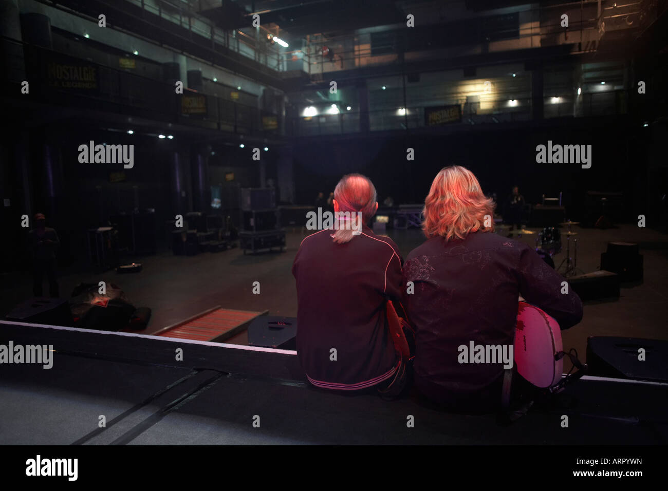 Francis Rossi and of Status Quo sit on the stage after their sound check while on European tour at L'Aeronef in Lille France Stock Photo