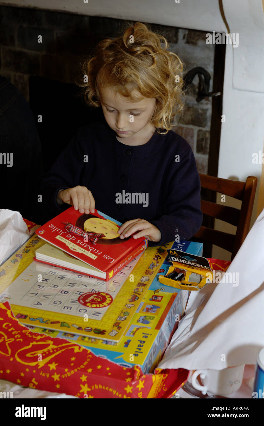 Four year old girl opening gifts on her birthday. Stock Photo