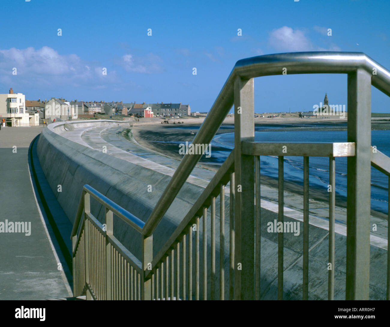 Stainless steel hand railing and reinforced concrete wave wall, Newbiggin-by-the-Sea, Northumberland, England, UK. Stock Photo