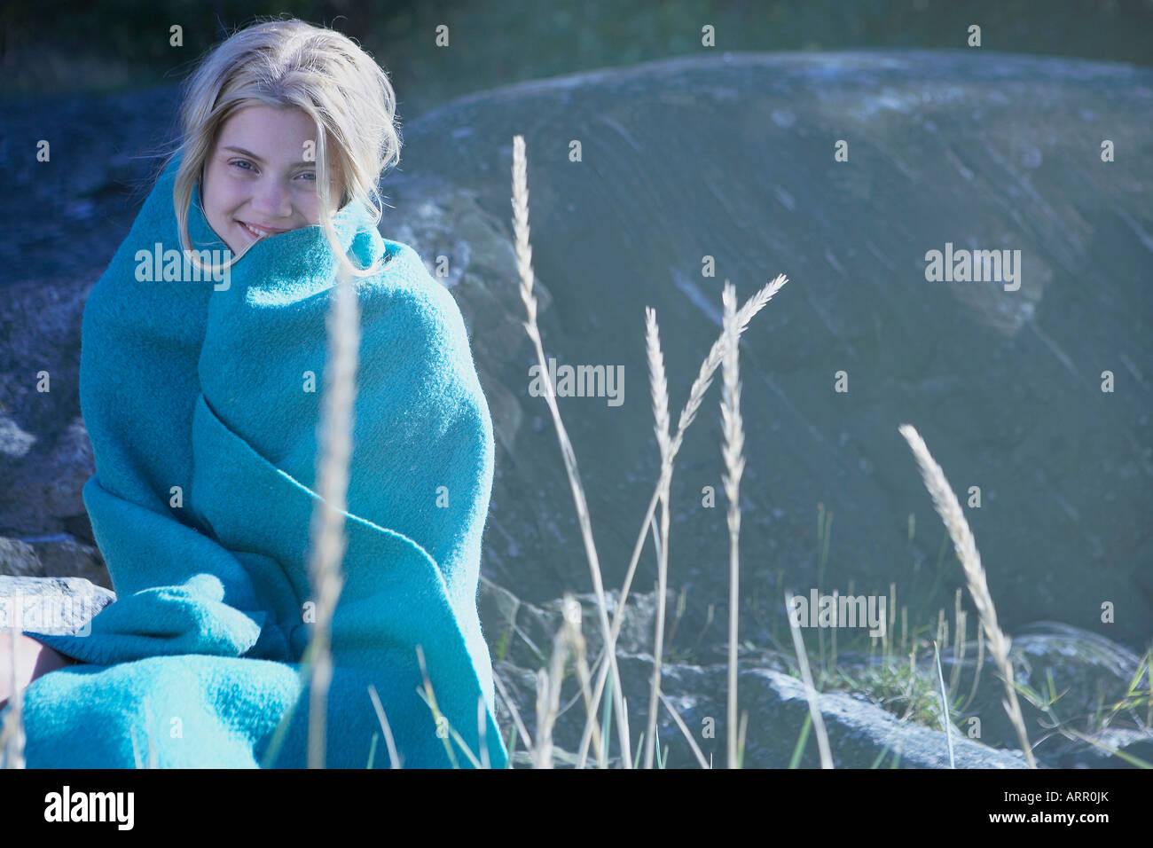 Young Woman wrapped in blanket Stock Photo - Alamy