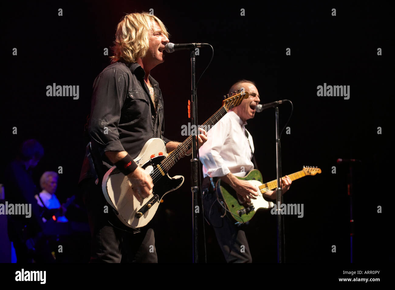 Rick Parfitt and Francis Rossi of rock band Status Quo play guitar riffs during gig on European tour in Lille France Stock Photo
