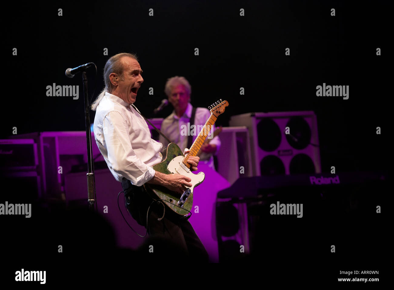 Francis Rossi and musician John Rhino Edwards of rock band Status Quo play guitar during gig on European tour in France Stock Photo