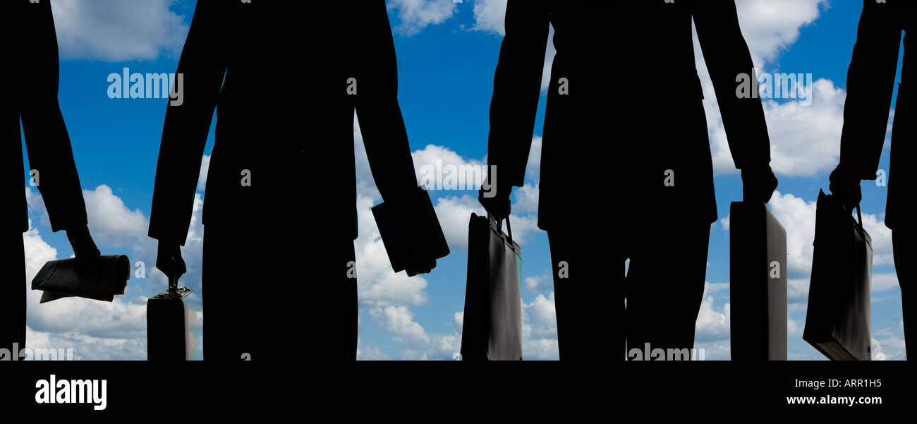 silhouette of business men and women going to work in large United States city Stock Photo