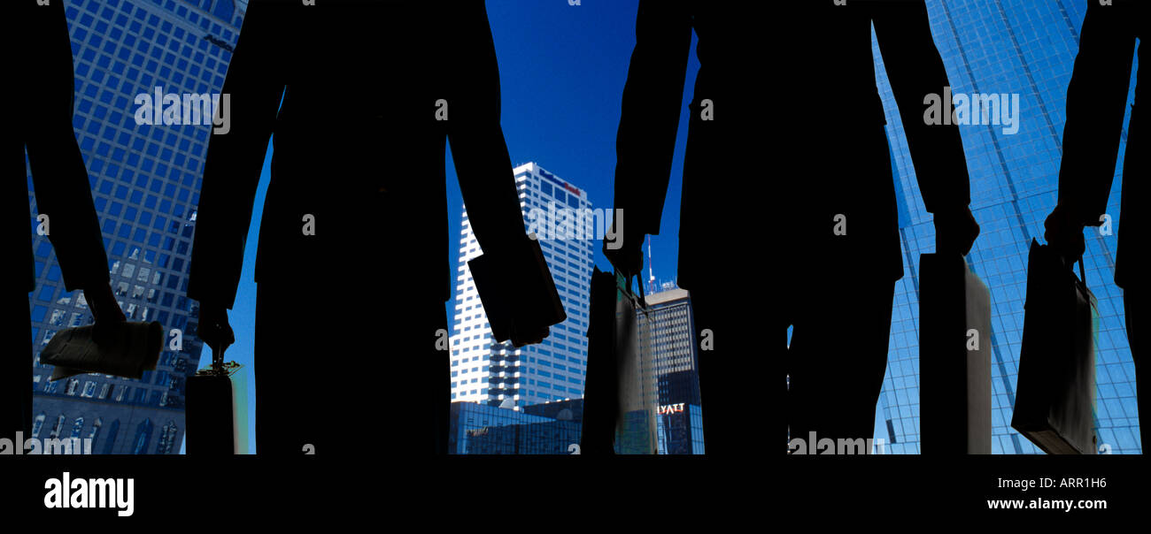 silhouette of business men and women going to work in large United States city Stock Photo