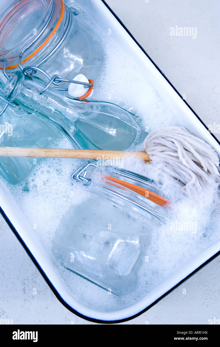 Enamel Washing up bowl and glassware Stock Photo Alamy