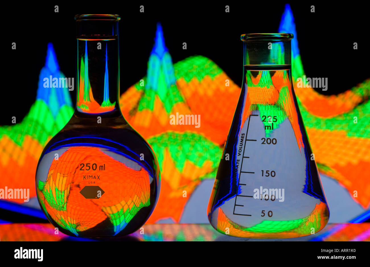 two beakers in front of  colorful spectral mapped data graph Stock Photo