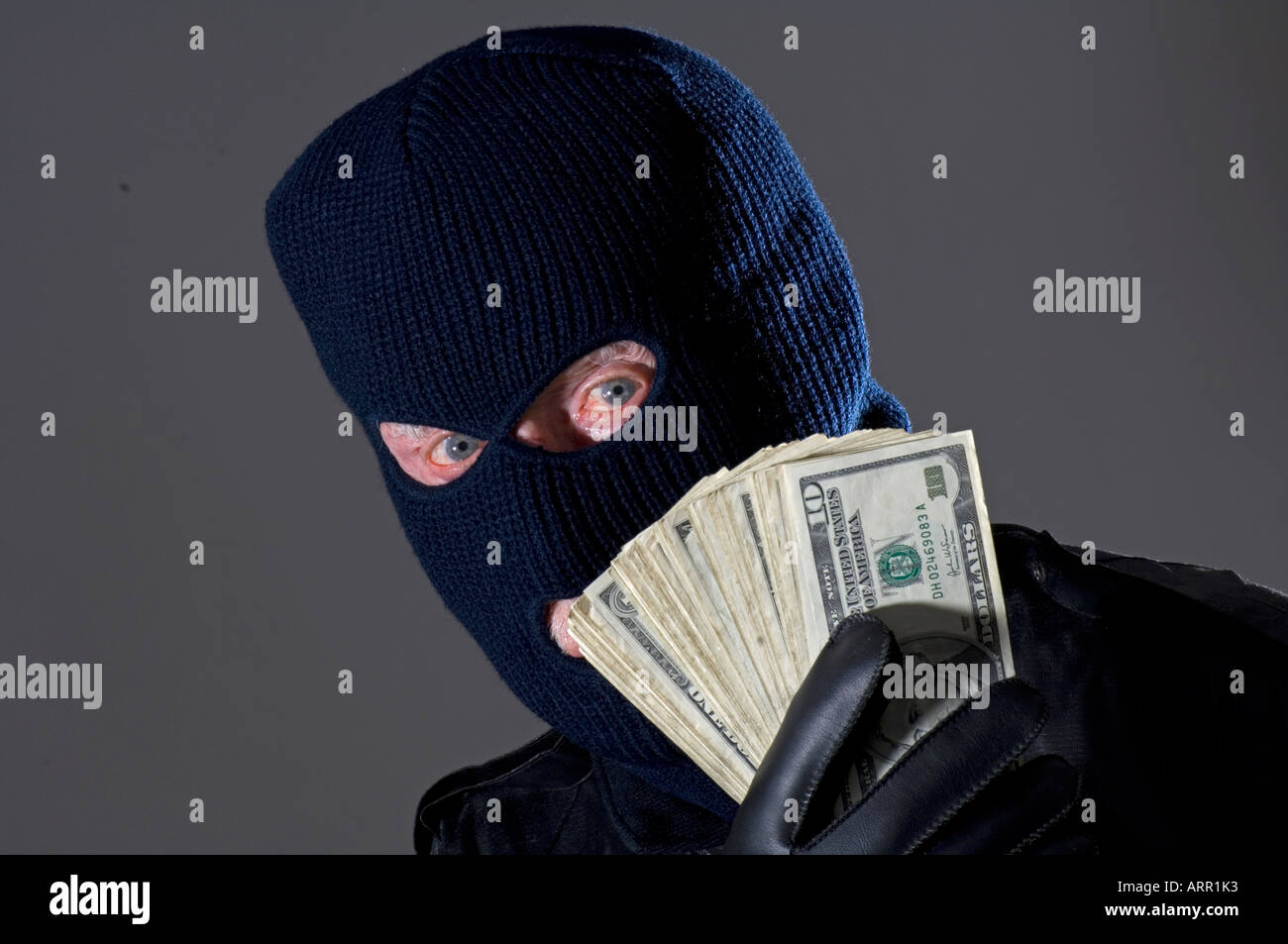 bad guy man flashlight wearing ski mask Stock Photo