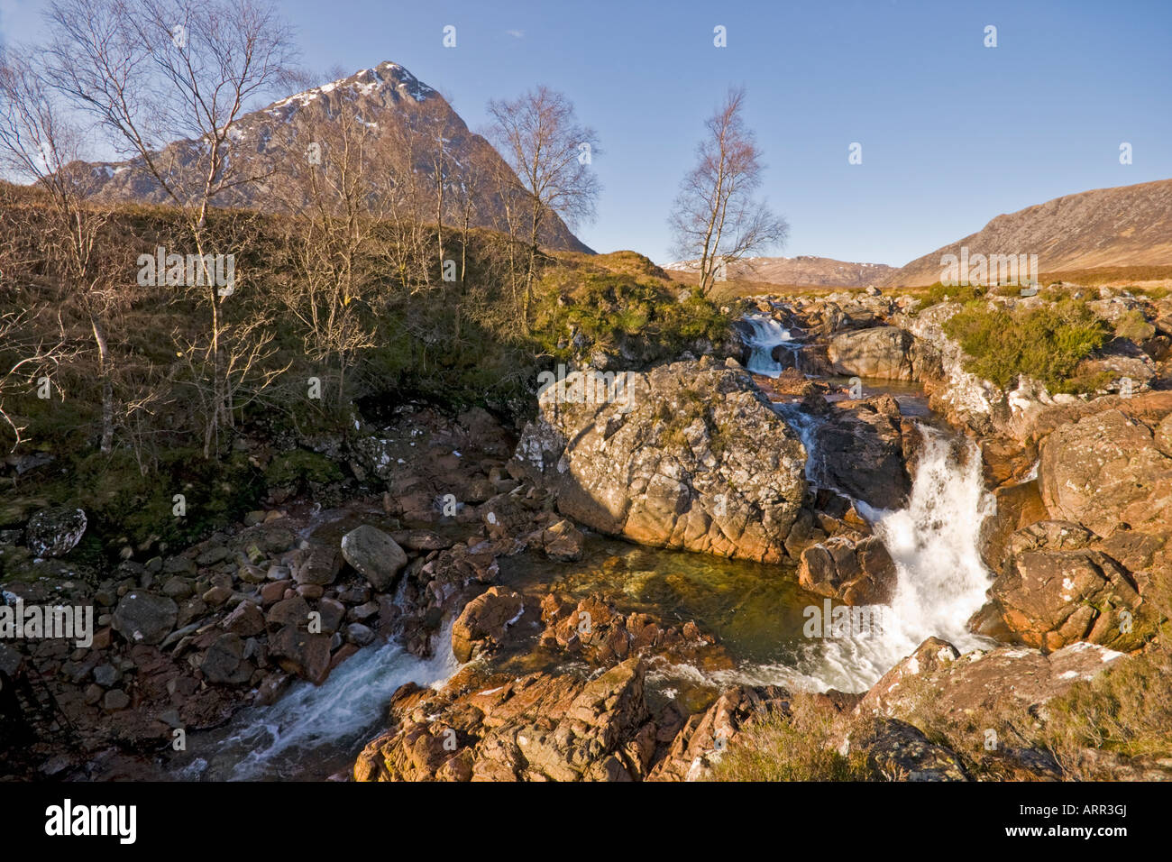 Stob Dearg at the north end of Buachaille Etive Mor in Glen Coe Scotland with River Etive tributory rushing through the Etive Mor waterfall Stock Photo