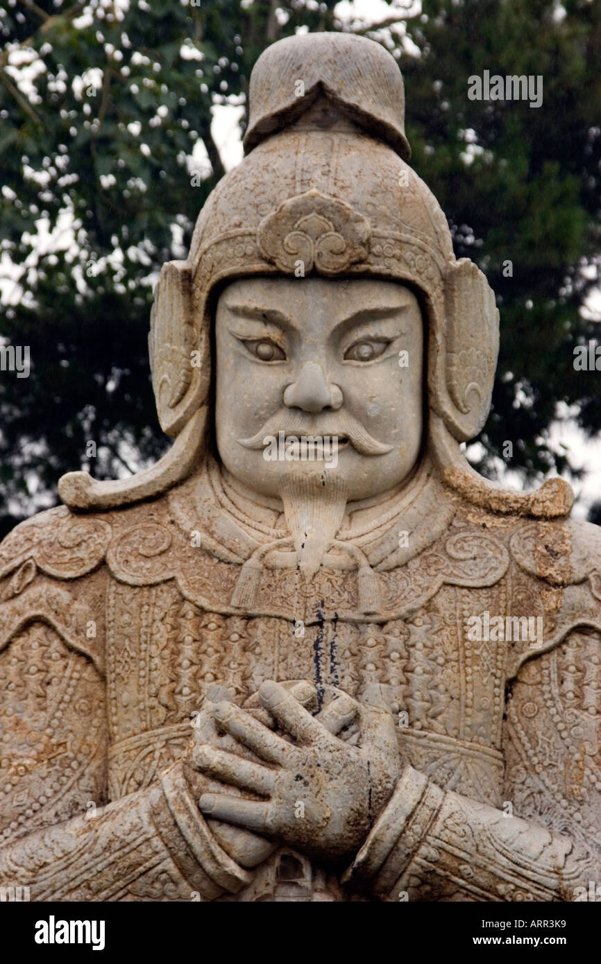 Stone statue of a General Warrior with hands clasped across his chest on the Sacred Way guarding