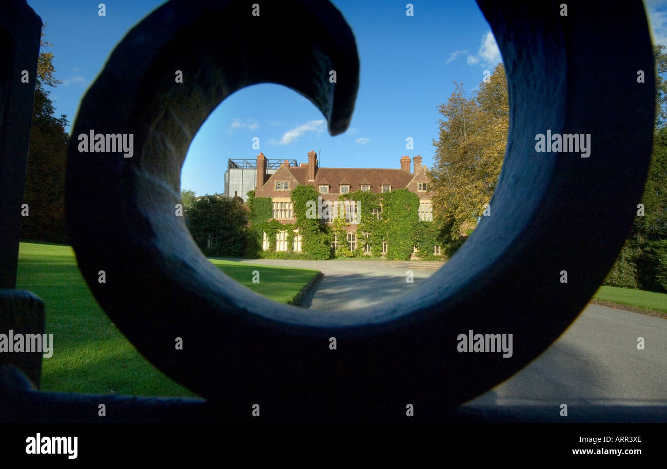 The Glyndebourne Opera House in East Sussex framed by the gates in afternoon sunshine. Picture