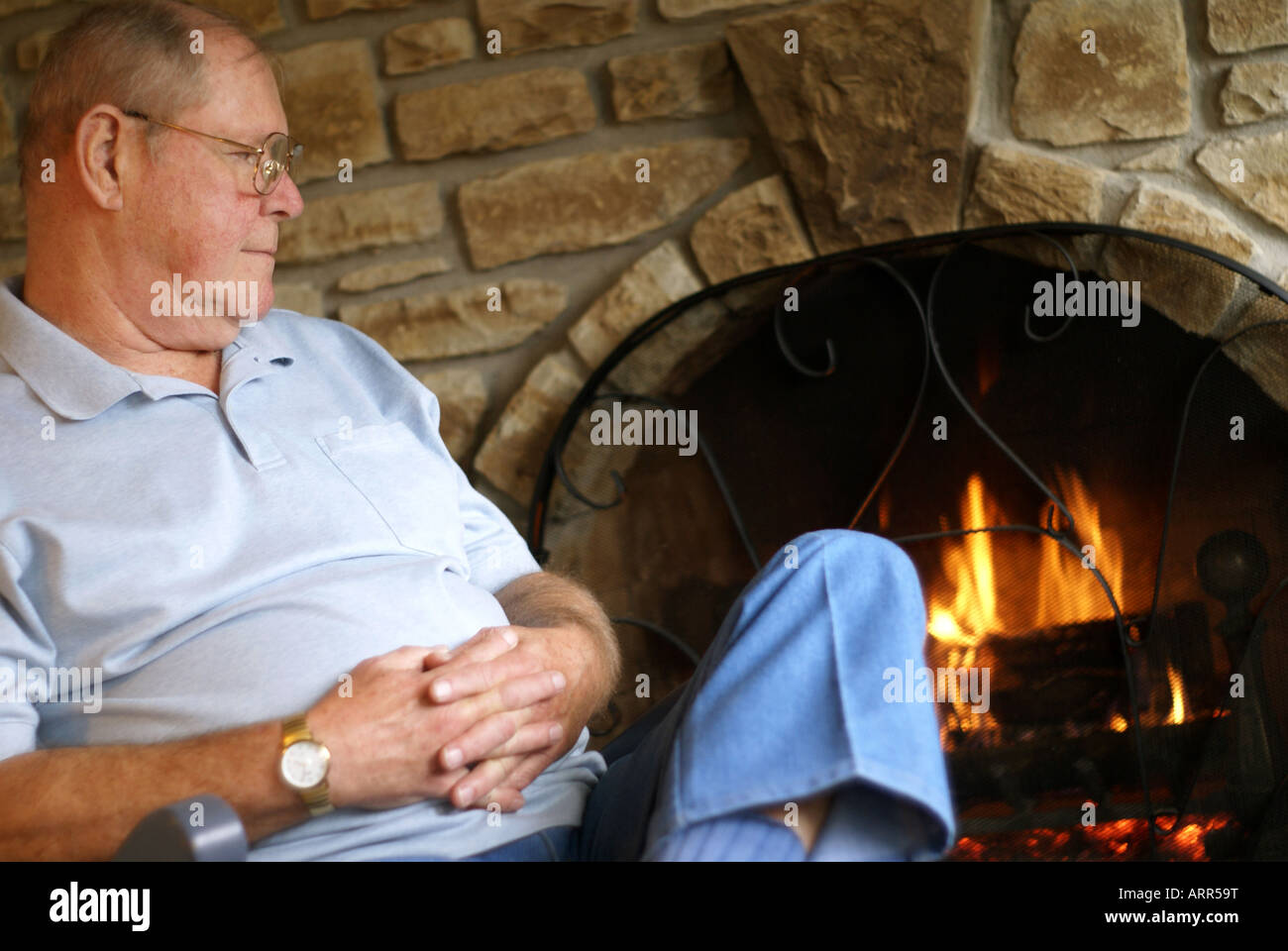Sitting by the Fireplace Stock Photo - Alamy