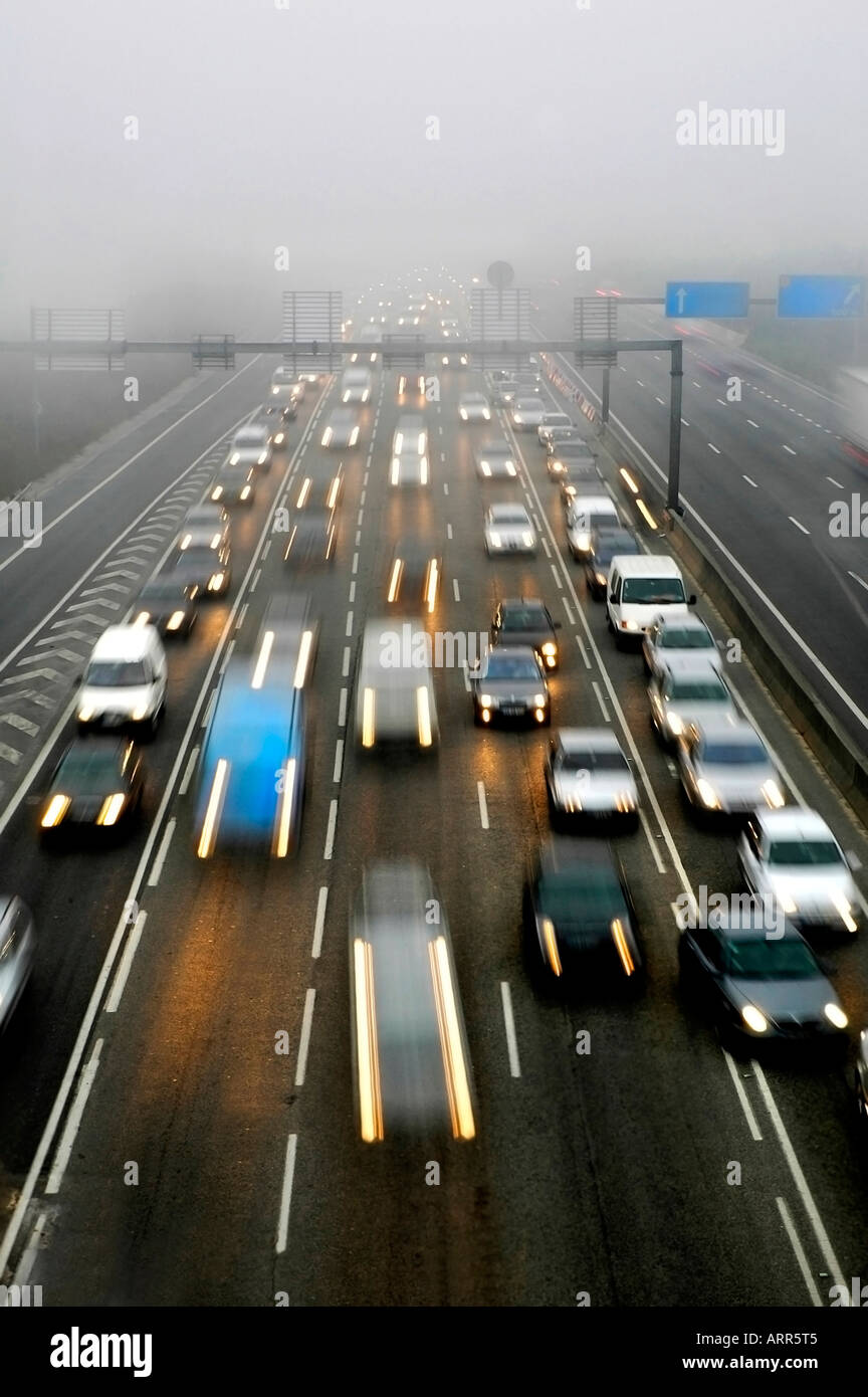 Speedway transport cars traffic in a fog morning Stock Photo