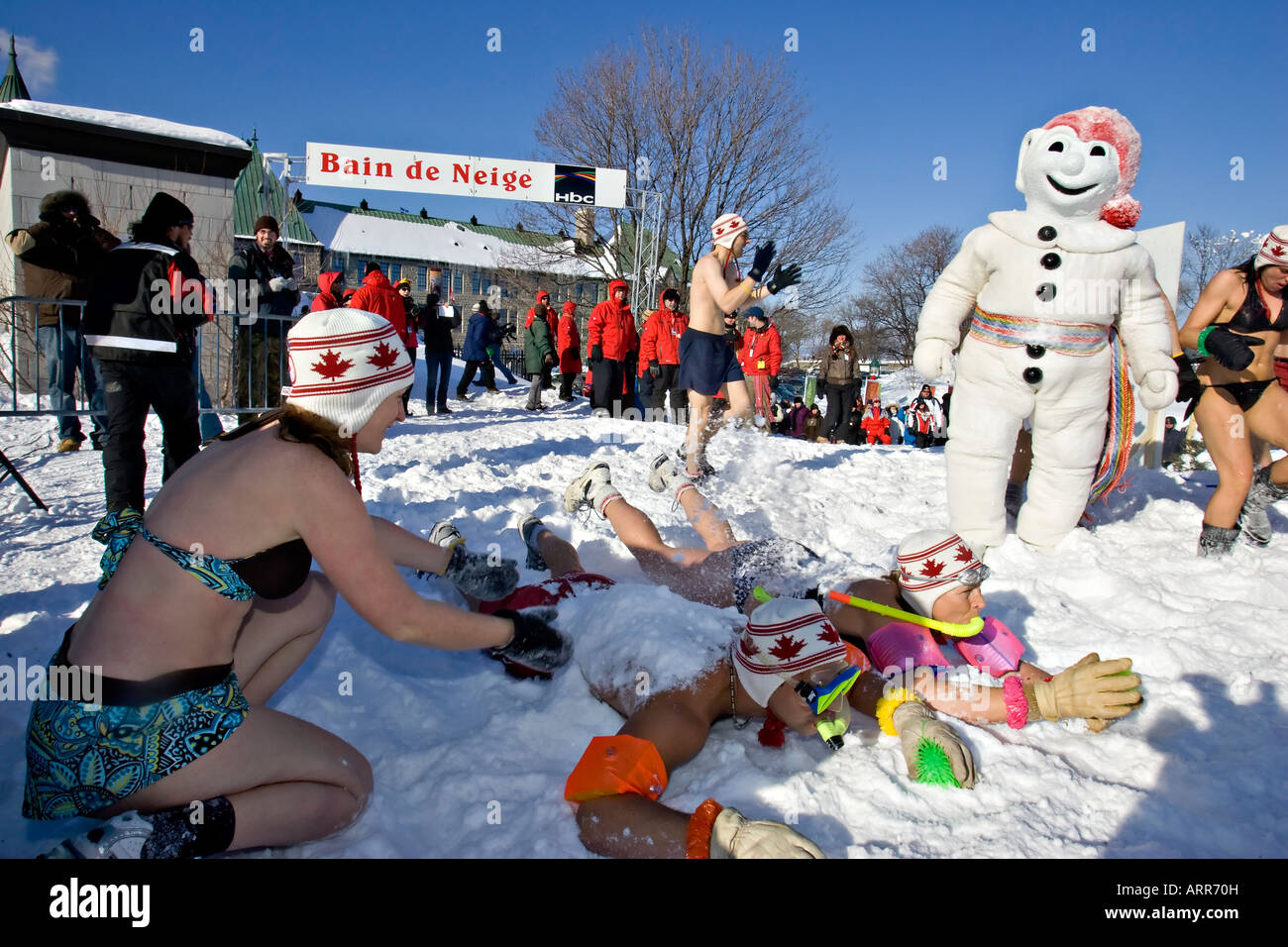 Carnival goers have fun with Bohomme Carnaval during the annual Snow Bath an highlight of the Quebec Winter Carnival Stock Photo