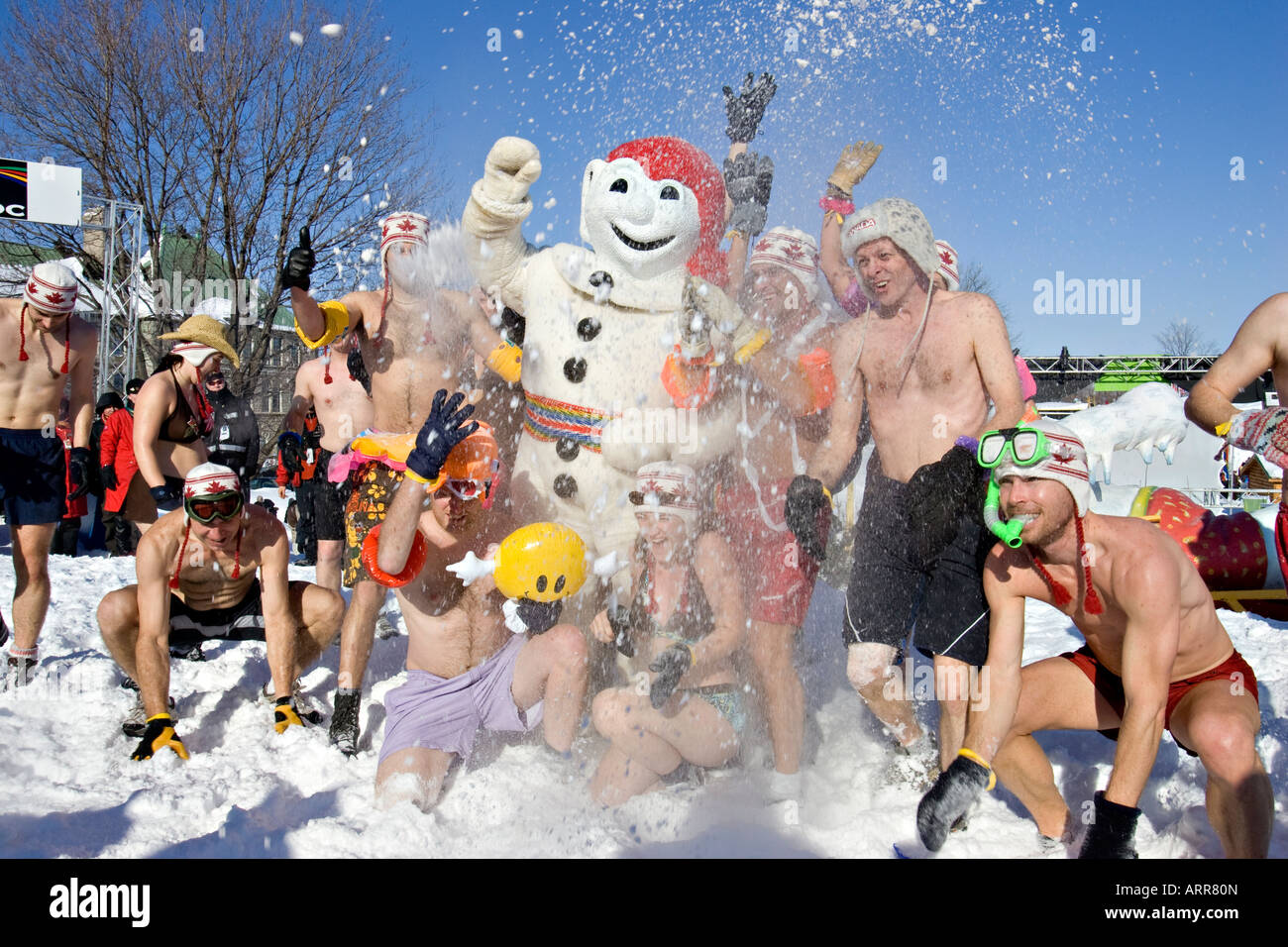Carnival goers have fun with Bohomme Carnaval during the annual Snow Bath an highlight of the Quebec Winter Carnival Stock Photo