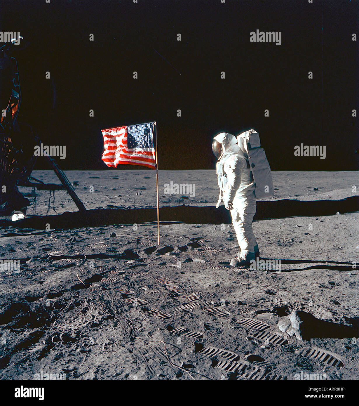 NASA Astronaut Buzz Aldrin standing on moon by American flag Stock Photo