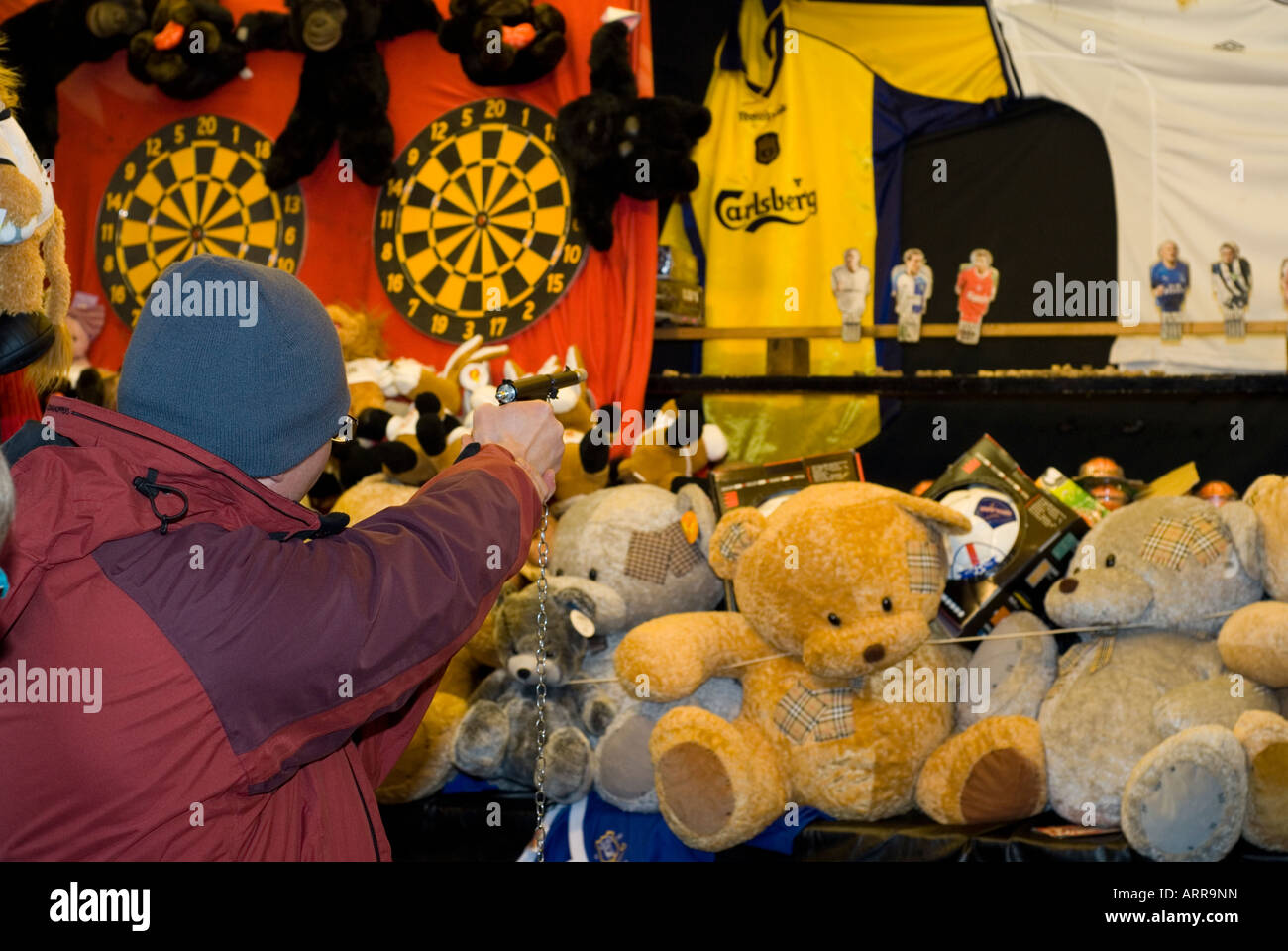 Man shooting with a toy gun in a funfair in Manchester UK Stock Photo